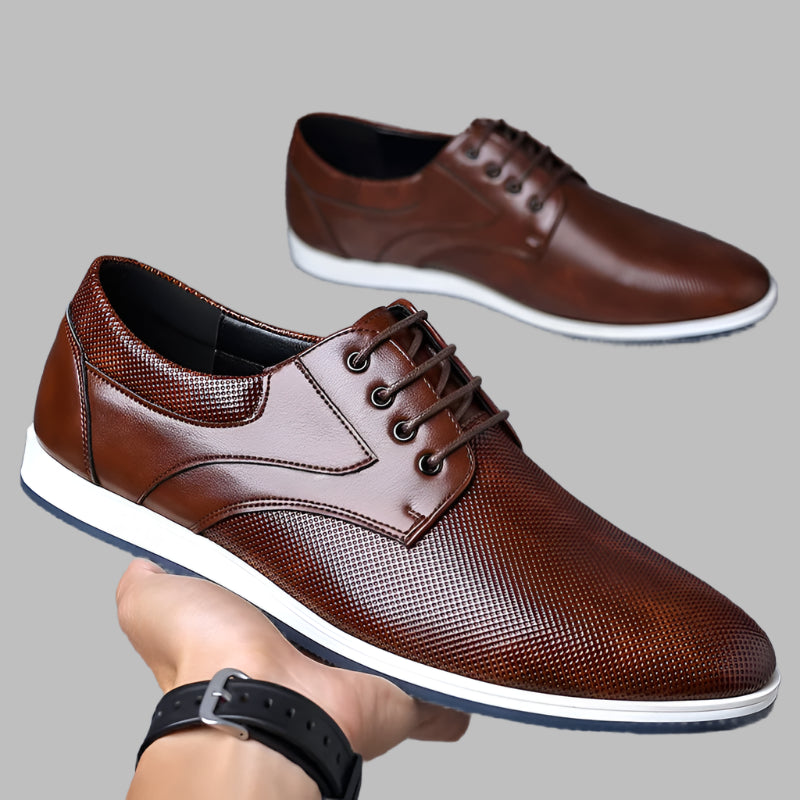 Mens-brown-leather-shoes-in-hand